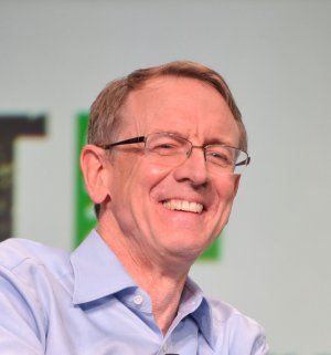 Venture capitalist John Doerr smiling on stage at TechCrunch Disrupt in 2013