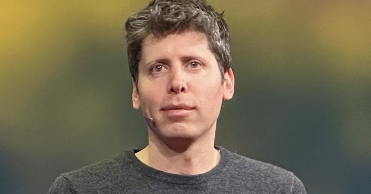 OpenAI CEO Sam Altman, wearing a gray sweater, speaks on stage at TED in April 2025.
