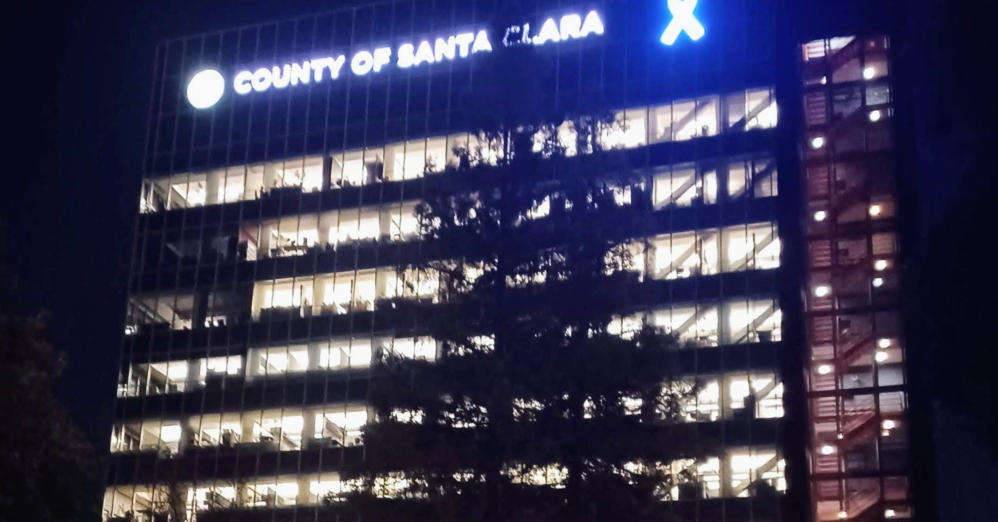 The County of Santa Clara Government Center office tower in downtown San José lit up at night
