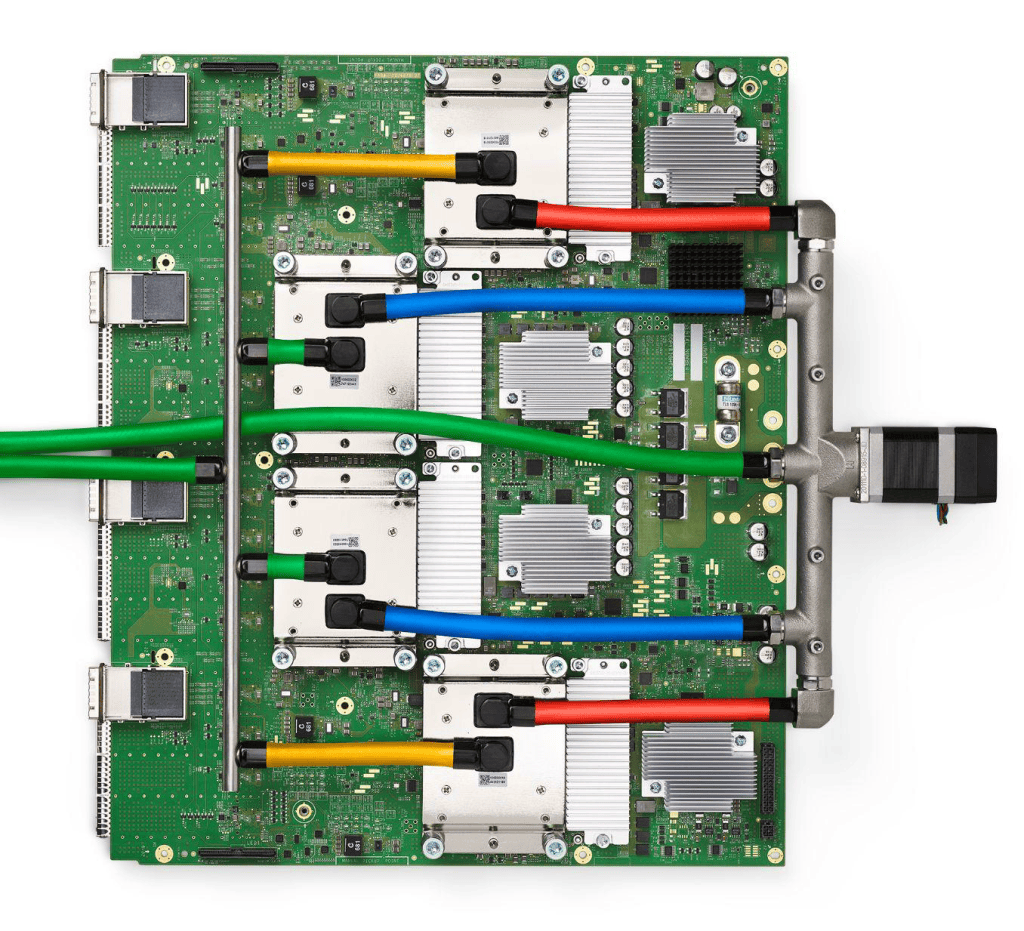 A Google TPU v4 circuit board holding four liquid-cooled processor packages